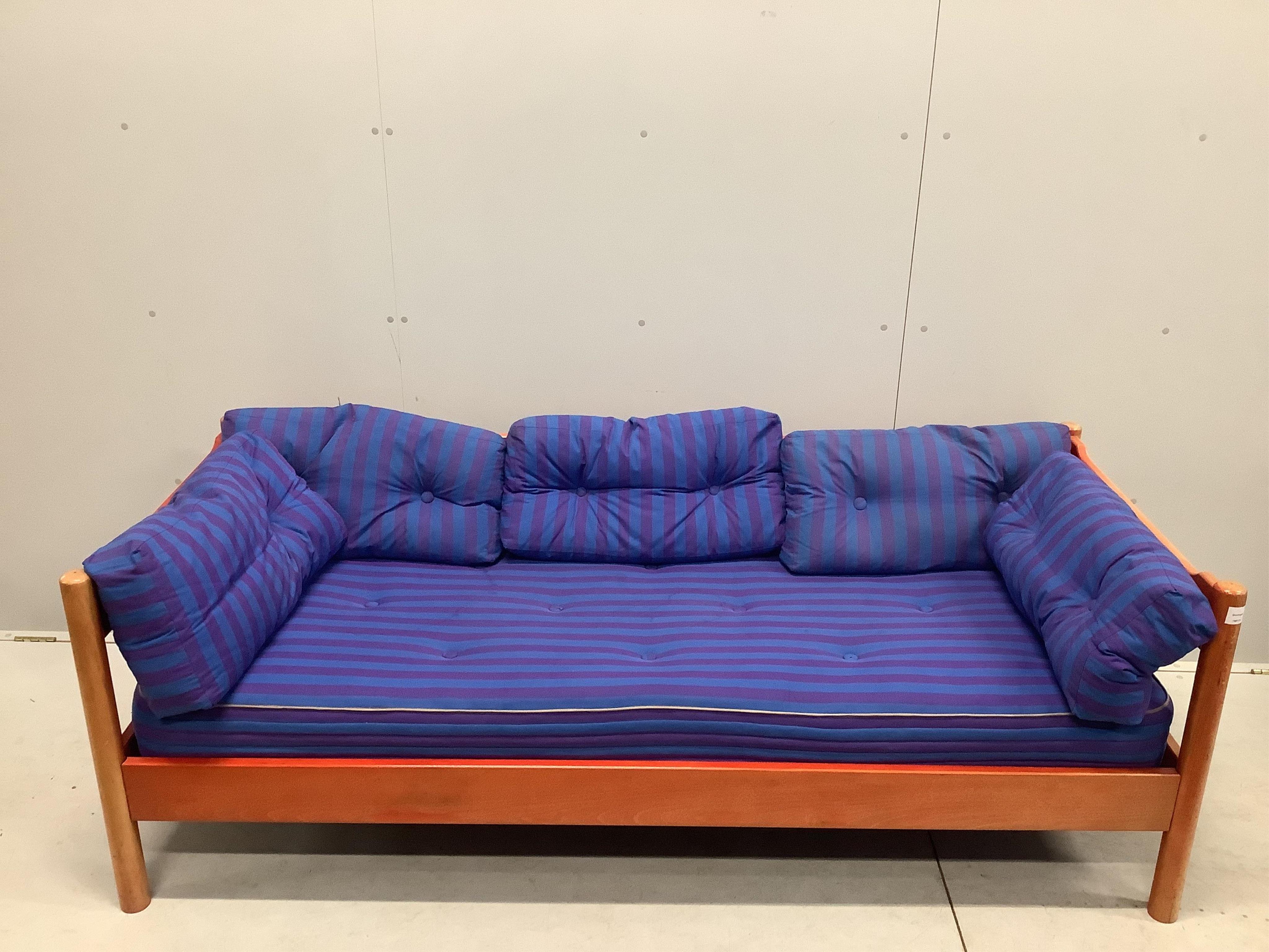 An early Habitat Magistretti style red stained beech settee, width 198cm, depth 84cm, height 69cm and a matching elbow chair. Condition - poor to fair